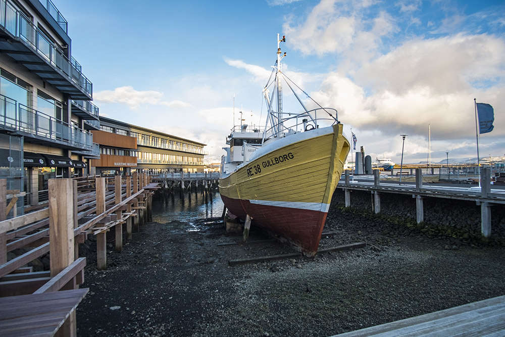 a yellow boat in dry dock