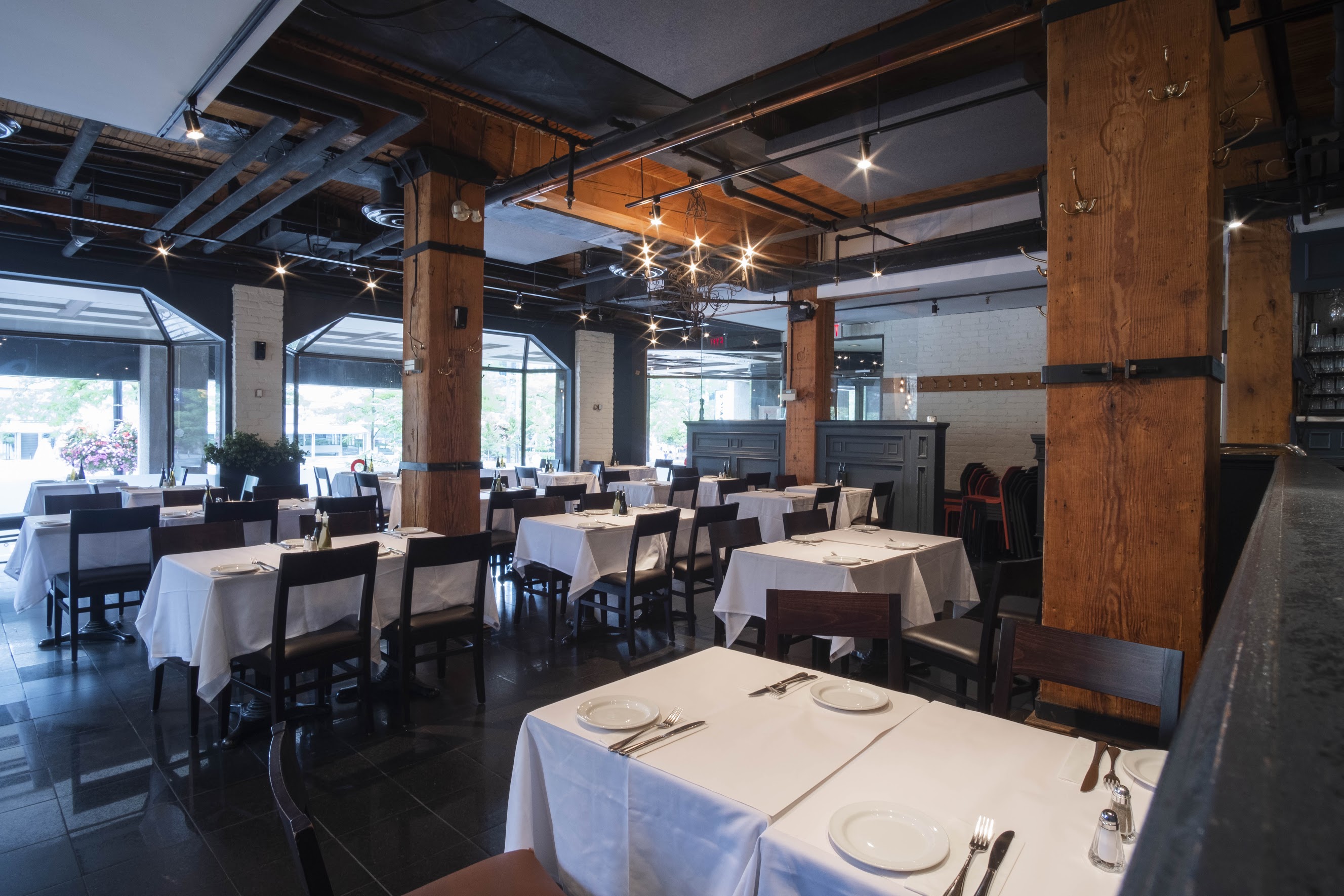 inside of restaurant table seating area with exposed historical wood beams and pillars