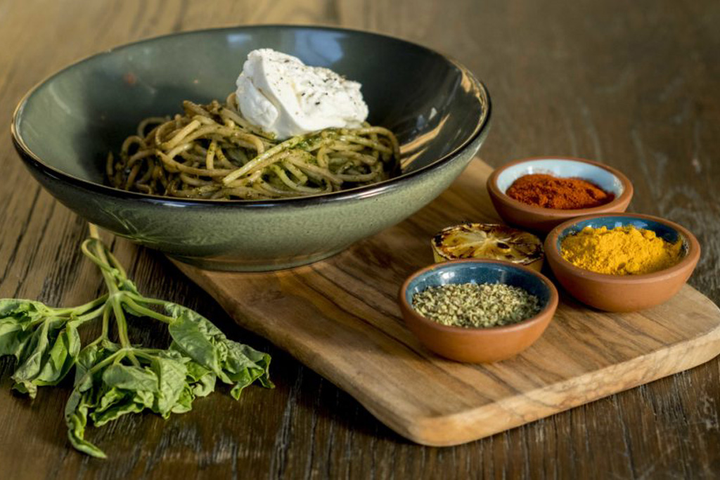 pizza with little bowls of spices