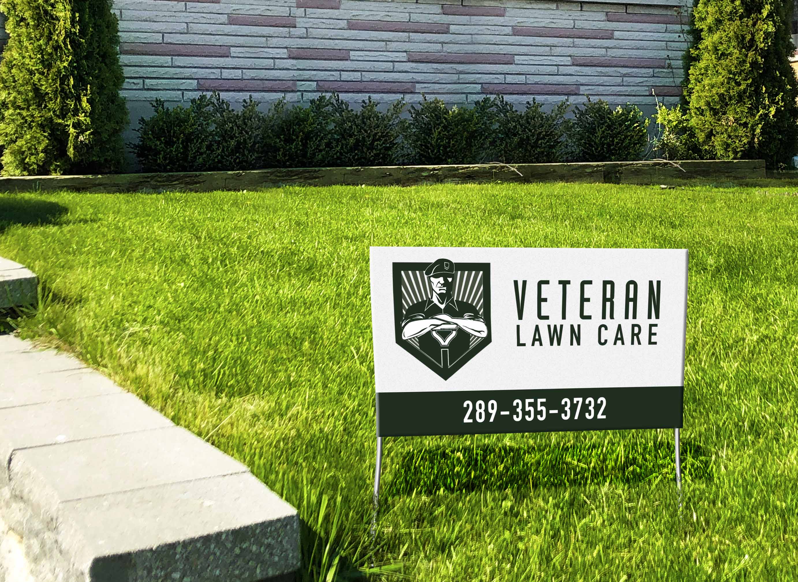 a bright green lawn, freshly cut, with a sign in it that reads veteran law care.