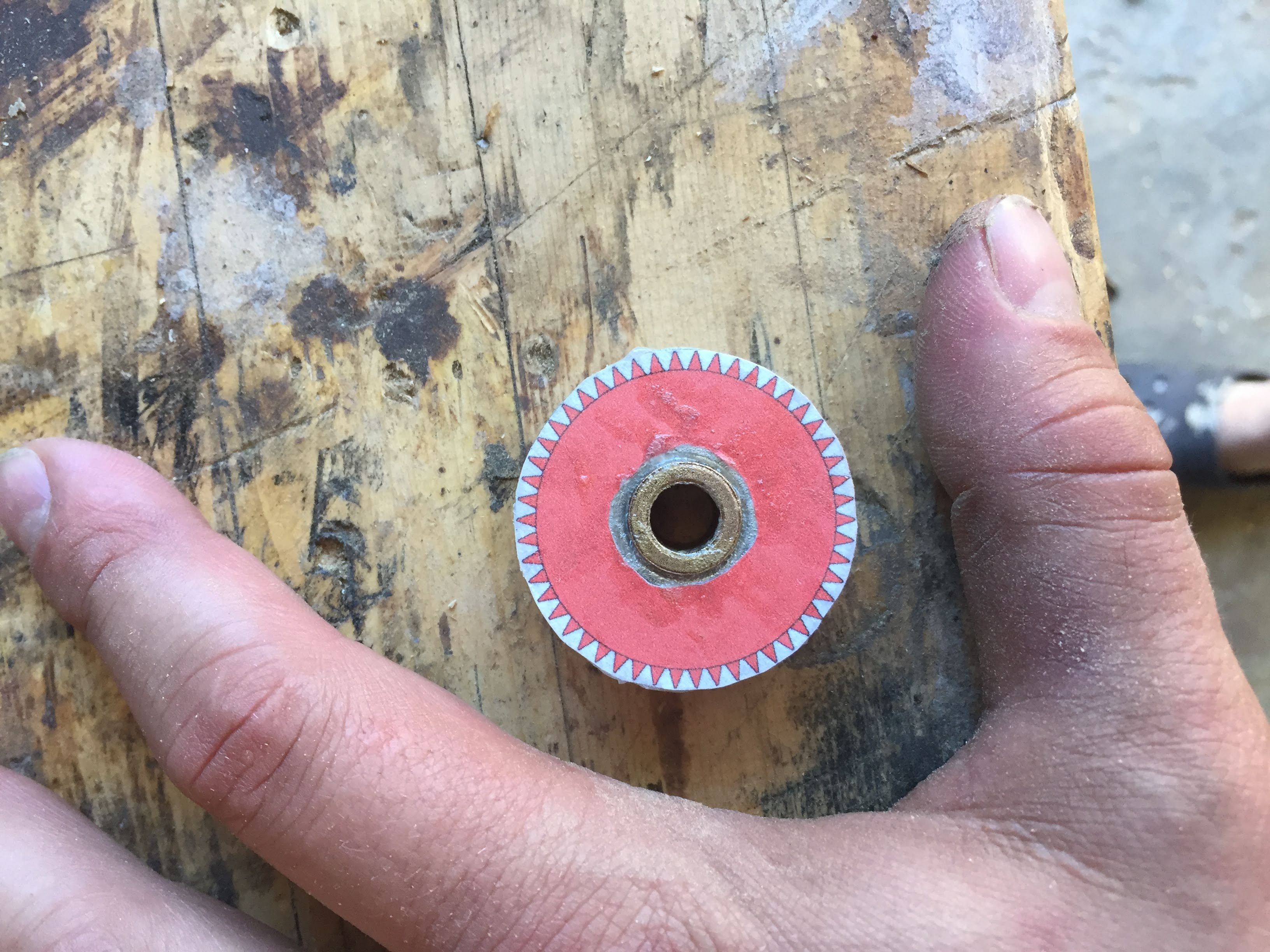 cilinder of metal 1.5inch wide .75inch tall with a paper gear tempalte glued to it