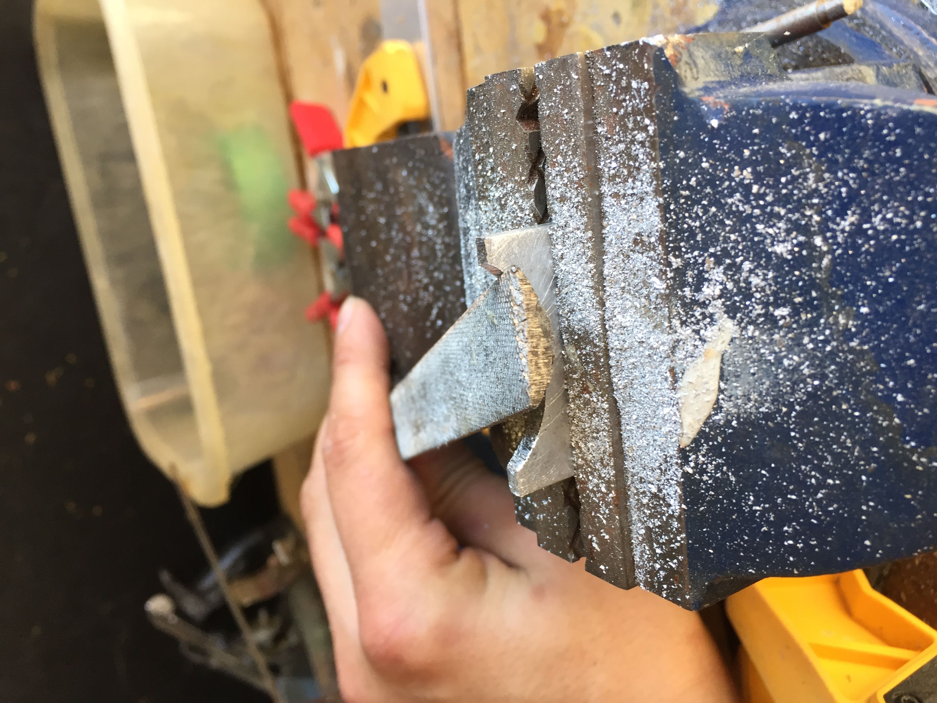 two pieces of metal being cut in a vice to form tool body