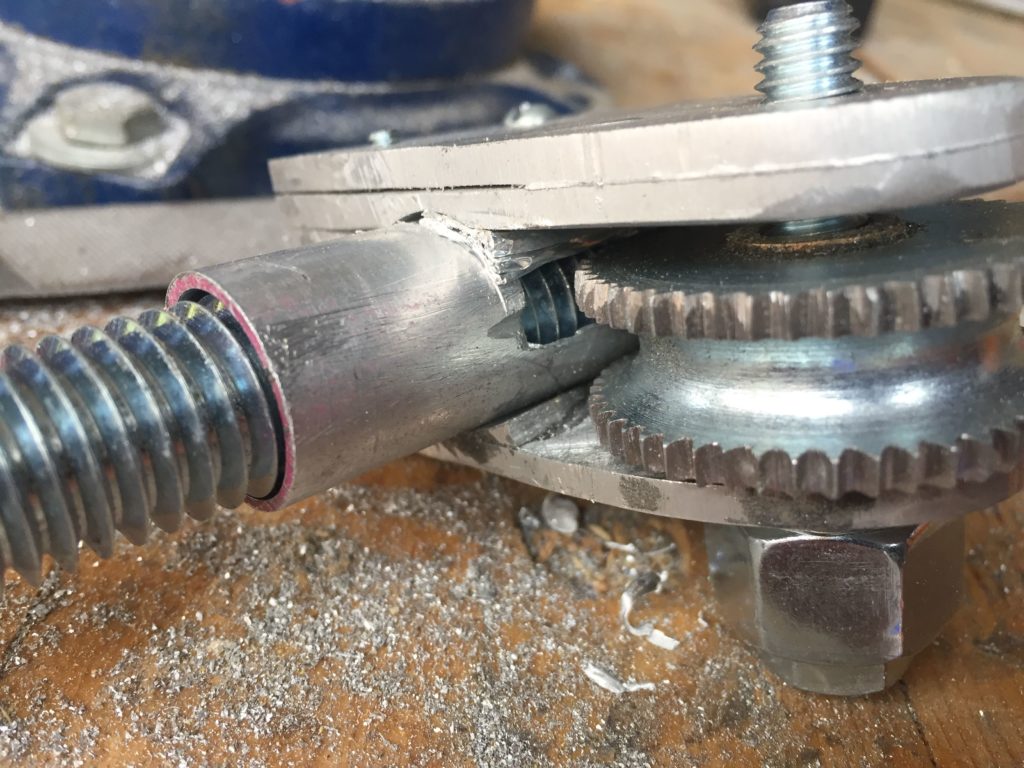 closeup of the complete one handed click rule tool. It is a handle about 1.5 feet long with a gear on one end than can be spun with the thumb