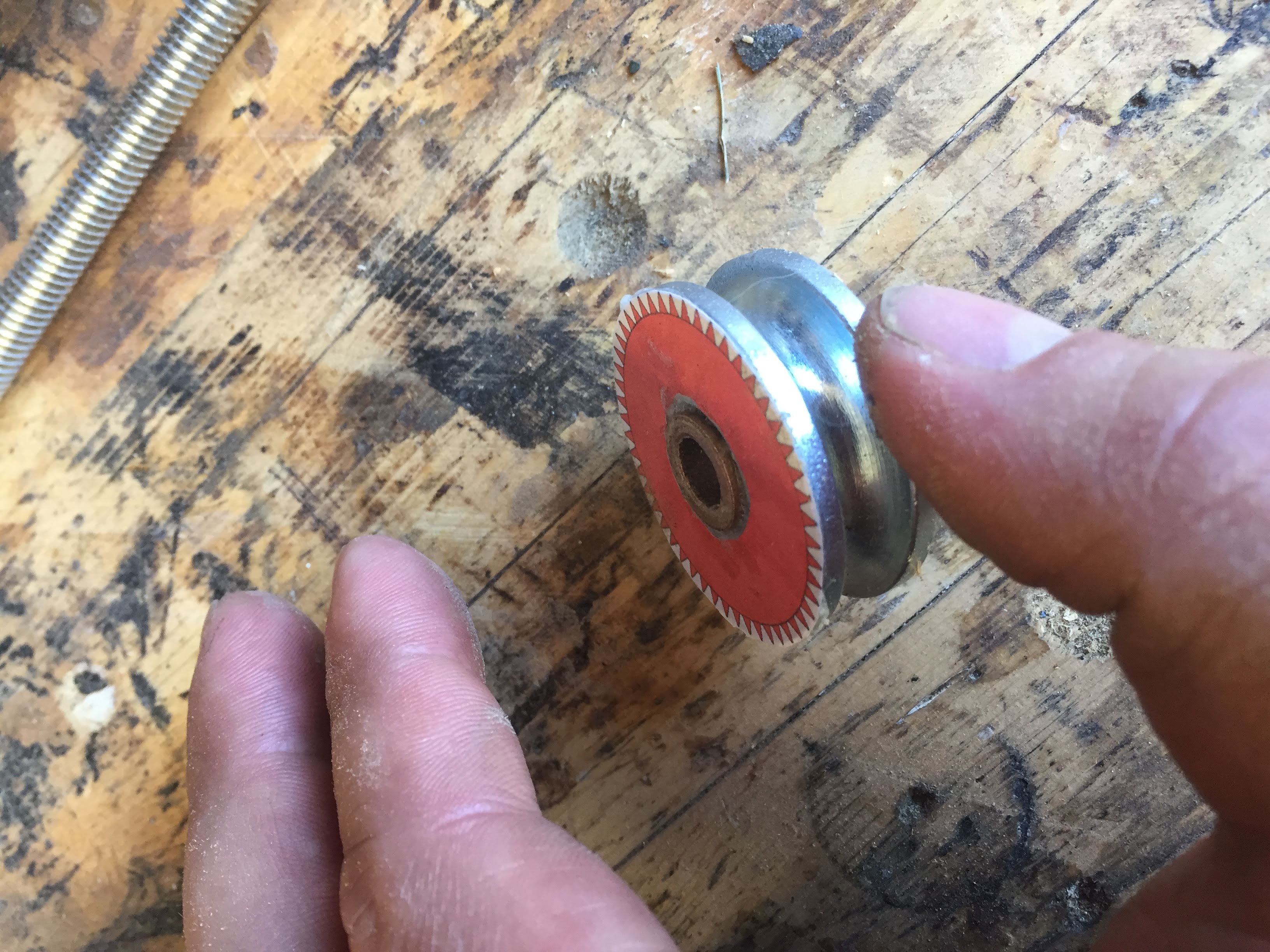 cylinder of metal 1.5inch wide .75inch tall with a paper gear tempalte glued to it